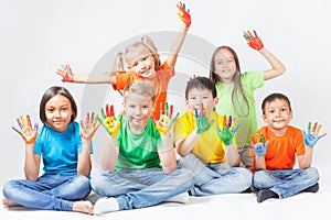 Happy kids with painted hands smiling