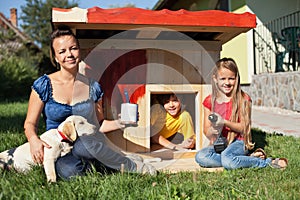 Happy kids painting the doghouse
