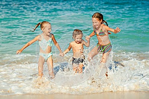 Happy kids playing on beach