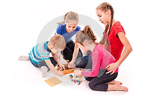 Happy kids playing with building blocks isolated on white