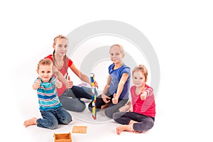 Happy kids playing with building blocks isolated on white