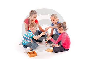 Happy kids playing with building blocks isolated on white