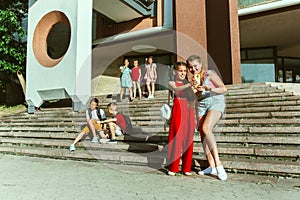 Happy kids playing at city`s street in sunny summer`s day