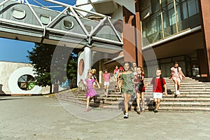 Happy kids playing at city`s street in sunny summer`s day