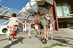 Happy kids playing at city`s street in sunny summer`s day