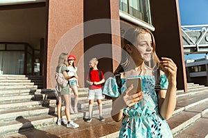 Happy kids playing at city`s street in sunny summer`s day