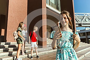 Happy kids playing at city`s street in sunny summer`s day