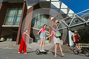 Happy kids playing at city`s street in sunny summer`s day