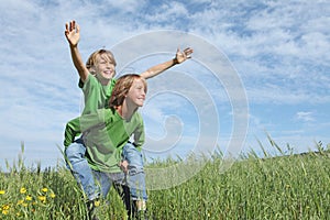 Happy kids playing piggyback race photo