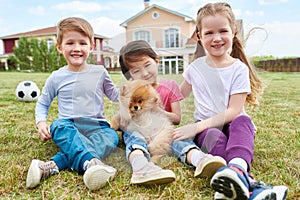 Happy Kids Playing with Puppy