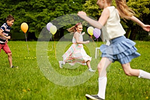 Happy kids playing tag game at birthday party