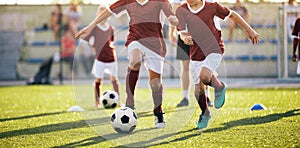 Happy Kids Practicing Soccer on Schoolyard. Young Coach With Children Football Players on Training Session