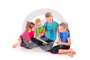 Happy kids reading a book on white