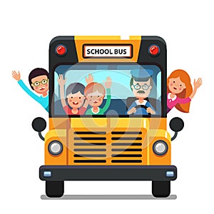 Happy kids riding on a school bus with driver photo