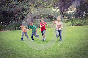 Happy kids running across the grass