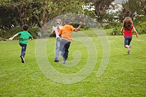 Happy kids running across the grass