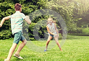 Happy kids running and playing game outdoors