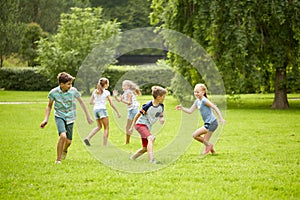 Happy kids running and playing game outdoors