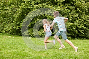 Happy kids running and playing game outdoors