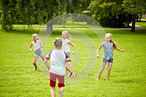 Happy kids running and playing game outdoors