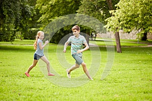 Happy kids running and playing game outdoors