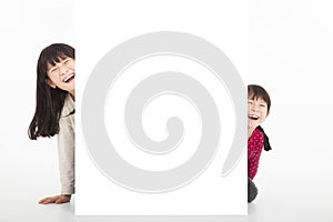 Happy kids showing blank billboard