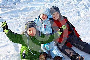 Happy kids sitting in snow