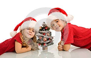Happy kids with small christmas tree