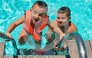 Happy kids in the swimming pool