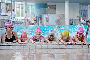 Happy kids at the swimming pool. young and successful swimmers pose.