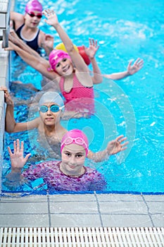 Happy kids at the swimming pool. young and successful swimmers pose.