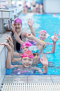 Happy kids at the swimming pool. young and successful swimmers pose.