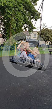 Happy kids are swinging on the hummock