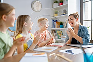 Happy kids and teacher at school