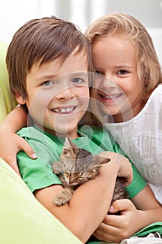 Happy kids with their new pet - a little kitten