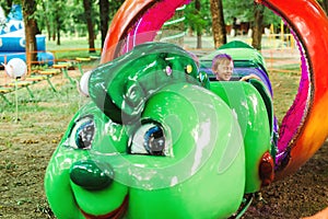 Happy kids on a thrilling roller coaster ride. Little boy in amusement park. Family having fun together at an amusement park