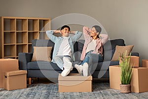 Happy Korean Couple Resting Leaning On Couch At Home