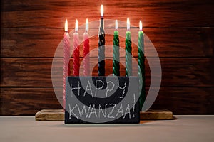 Happy Kwanzaa. African American holiday. Seven candles red, black and green photo