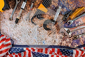 Happy Labor day American flag and construction tools. Copy space background