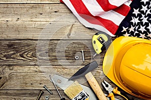 Happy Labor day American national holiday greeting card template. Flat lay yellow safety helmet, flag of USA, building tools on