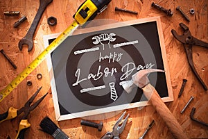 Happy Labor day background concept. Blackboard on wood with grunge and rusty  engineering handy tools arounds. Mockup chalkboard