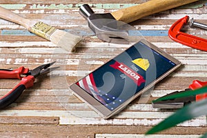 Happy labor day background concept. Flat lay mobile Phone With Happy Labor Day USA Holiday and essential construction tools worker
