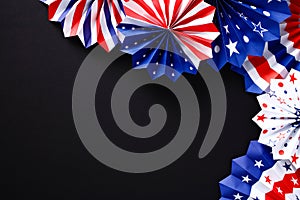 Happy Labor Day banner design. Flat lay American paper fans on black background. USA patriotic decorations top view