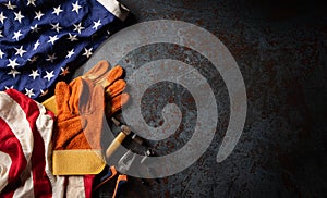 Happy Labor day concept. American flag with different construction tools on dark stone background, with copy space for text