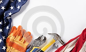 Happy Labor day concept. American flag with different construction tools on white background, with copy space for text