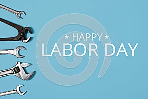 Happy labor day concept. Banner with Different wrenches on blue background