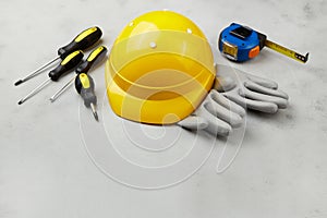 Happy labor day concept. Construction tools, yellow helmet on dark wooden background