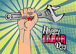 Happy Labor Day lettering. Cartoon female hand with manicure holds adjustable wrench.