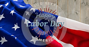 Happy labor day text against american flag on wooden background