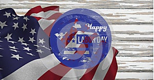 Happy labor day text on circular banner over american flag against wooden background